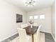 Dining room with modern light fixture and three windows at 6216 N Woods Edge Ct, McCordsville, IN 46055