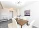 Inviting dining room featuring a wood table, white chairs, light fixture, and minimalist artwork at 6216 N Woods Edge Ct, McCordsville, IN 46055