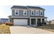 Charming two-story home featuring a two-car garage, covered porch, and a combination of brick and siding at 6216 N Woods Edge Ct, McCordsville, IN 46055