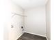 Functional laundry room includes hookups and overhead shelving at 6216 N Woods Edge Ct, McCordsville, IN 46055