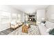 Bright living room featuring modern furniture, stylish rug, and seamless flow to dining and kitchen areas at 6216 N Woods Edge Ct, McCordsville, IN 46055