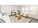Comfortable living room with stylish decor, including a patterned rug, modern furniture, and ample natural light at 6216 N Woods Edge Ct, McCordsville, IN 46055