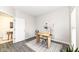 Well-lit office space featuring modern desk and gray floors; an open doorway leads to another room at 6216 N Woods Edge Ct, McCordsville, IN 46055