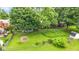 Spacious backyard features mature trees, lush grass, and a garden at 629 Williamsburg Ln, Greenwood, IN 46142