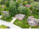 Aerial view of a house with mature trees and green lawns at 629 Williamsburg Ln, Greenwood, IN 46142