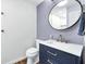 Stylish half bathroom with modern fixtures, floating vanity, and decorative mirror at 629 Williamsburg Ln, Greenwood, IN 46142