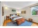 Cozy bedroom with hardwood floors, chest at the foot of the bed and natural light at 629 Williamsburg Ln, Greenwood, IN 46142