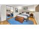 This bright bedroom features a full-length mirror, hardwood floors, a trunk, and two nightstands at 629 Williamsburg Ln, Greenwood, IN 46142