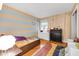 bedroom featuring hardwood floors, tree-themed wall art and a comfortable twin bed at 629 Williamsburg Ln, Greenwood, IN 46142