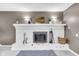 Close up of white brick fireplace with decor, mantel, and hearth at 629 Williamsburg Ln, Greenwood, IN 46142