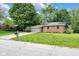 Charming brick home with a well-manicured lawn and mature trees at 629 Williamsburg Ln, Greenwood, IN 46142