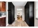 Hallway has luxury vinyl plank flooring, built in storage cabinets, and access to living room at 629 Williamsburg Ln, Greenwood, IN 46142