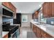 Modern kitchen with stainless steel appliances, a gas range, and a view of the backyard at 629 Williamsburg Ln, Greenwood, IN 46142