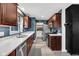 Bright kitchen with modern appliances, dark wood cabinets, and ample countertop space at 629 Williamsburg Ln, Greenwood, IN 46142