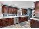 Well-appointed kitchen featuring dark wood cabinets, stainless steel appliances, and stylish countertops at 629 Williamsburg Ln, Greenwood, IN 46142