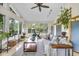Bright living room with large windows, ceiling fan, exercise equipment, and view of the landscaped backyard at 629 Williamsburg Ln, Greenwood, IN 46142