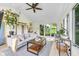 Open and airy living room with backyard access, neutral paint, ceiling fan, area rug and comfortable seating at 629 Williamsburg Ln, Greenwood, IN 46142