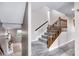 Carpeted staircase with wood railing leads to upper level of the home at 629 Williamsburg Ln, Greenwood, IN 46142