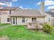 Manicured backyard featuring lush green grass and a wooden deck with outdoor seating at 6556 Aintree Ter, Indianapolis, IN 46250