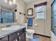Well-lit bathroom featuring modern fixtures, a bathtub with shower, and a window at 6556 Aintree Ter, Indianapolis, IN 46250
