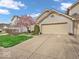 Attractive home featuring well-kept lawns, flowering trees, and a two-car garage at 6556 Aintree Ter, Indianapolis, IN 46250