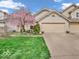Charming townhouse with a well-manicured front yard and a blossoming tree, offering curb appeal at 6556 Aintree Ter, Indianapolis, IN 46250
