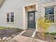 Inviting front entrance with a decorative wreath, wind chimes and well maintained landscaping at 6556 Aintree Ter, Indianapolis, IN 46250