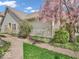 Charming home with vinyl siding and a well-manicured front yard with blooming trees at 6556 Aintree Ter, Indianapolis, IN 46250