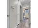 Hallway view leading to a bathroom with neutral walls and wood-look flooring at 6556 Aintree Ter, Indianapolis, IN 46250