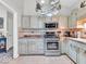 Kitchen showcases stainless appliances, decorative upper cabinets, and a unique hanging pot rack at 6556 Aintree Ter, Indianapolis, IN 46250