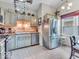 Traditional eat-in kitchen with stainless steel appliances, tiled flooring, and unique decor at 6556 Aintree Ter, Indianapolis, IN 46250