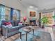 Bright living room featuring a cozy fireplace, stylish seating, and sliding glass doors to the patio at 6556 Aintree Ter, Indianapolis, IN 46250