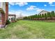 Expansive backyard featuring well-maintained lawn and privacy trees, perfect for outdoor enjoyment and entertaining at 6806 Powder Dr, Indianapolis, IN 46259