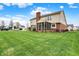 View of the large backyard featuring a screened-in porch on the rear of the house at 6806 Powder Dr, Indianapolis, IN 46259