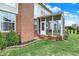 A view of the screened porch as seen from the backyard of the home at 6806 Powder Dr, Indianapolis, IN 46259