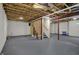 Expansive unfinished basement with exposed ceiling, offering versatile space for storage or future living areas at 6806 Powder Dr, Indianapolis, IN 46259