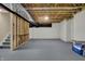 Spacious unfinished basement with exposed ceiling and gray concrete floor, offering potential for customization at 6806 Powder Dr, Indianapolis, IN 46259