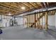 Unfinished basement with exposed beams and walls, showcasing the home's infrastructure and potential for future expansion at 6806 Powder Dr, Indianapolis, IN 46259