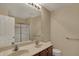 Bathroom with a double sink vanity, a large mirror, and a glass-enclosed shower for modern convenience at 6806 Powder Dr, Indianapolis, IN 46259