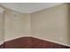 Minimalist bedroom with hardwood floors, neutral paint, and a large window at 6806 Powder Dr, Indianapolis, IN 46259