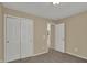 Bedroom with neutral walls, carpet flooring, and closet for convenient storage at 6806 Powder Dr, Indianapolis, IN 46259