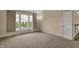 An empty carpeted bedroom with natural light and neutral-colored walls at 6806 Powder Dr, Indianapolis, IN 46259