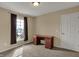 Bedroom with neutral carpet and walls and a writing desk near the window at 6806 Powder Dr, Indianapolis, IN 46259