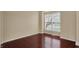 Cozy bedroom featuring hardwood floors, neutral walls, and a bright window at 6806 Powder Dr, Indianapolis, IN 46259