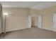 A bright empty carpeted bedroom with an open doorway at 6806 Powder Dr, Indianapolis, IN 46259