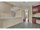 An open dining area with view of stairs and kitchen cabinets at 6806 Powder Dr, Indianapolis, IN 46259