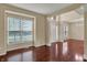 Open-concept entryway with gleaming hardwood floors and large windows for ample natural light at 6806 Powder Dr, Indianapolis, IN 46259