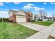 Inviting two-story home with attached garage, lush lawn, and convenient sidewalk access at 6806 Powder Dr, Indianapolis, IN 46259