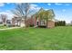Well-maintained two-story home features a spacious lawn and mature trees, enhancing its curb appeal at 6806 Powder Dr, Indianapolis, IN 46259