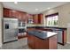 A spacious kitchen featuring stainless steel appliances, dark countertops, and wooden cabinets at 6806 Powder Dr, Indianapolis, IN 46259